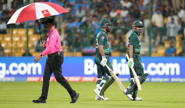Pakistan's captain Babar Azam and Fakhar Zaman leave the ground after rain interrupted the play | AP